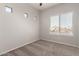 Neutral bedroom featuring a window and carpeted floors at 10009 W Bloch Rd, Tolleson, AZ 85353