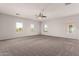 Spacious primary bedroom with neutral carpet, ceiling fan, and bright windows at 10009 W Bloch Rd, Tolleson, AZ 85353
