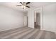 Neutral bedroom featuring a ceiling fan, carpeted floors, and an attached bathroom at 10009 W Bloch Rd, Tolleson, AZ 85353