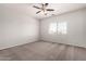 Cozy bedroom featuring neutral paint, carpet, a window, and a ceiling fan at 10009 W Bloch Rd, Tolleson, AZ 85353
