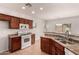 A well-lit kitchen features dark cabinetry, a gas range, and matching countertops at 10009 W Bloch Rd, Tolleson, AZ 85353