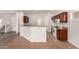 Charming kitchen area with breakfast bar, dark wood cabinets, and white appliances at 10009 W Bloch Rd, Tolleson, AZ 85353