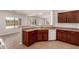 The kitchen has dark cabinets and a breakfast bar looking into the living room at 10009 W Bloch Rd, Tolleson, AZ 85353
