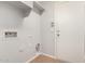 Clean laundry area with built in shelving and tile floors at 10009 W Bloch Rd, Tolleson, AZ 85353
