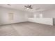 The upstairs loft area has carpet and is a versatile space with good lighting at 10009 W Bloch Rd, Tolleson, AZ 85353
