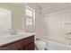 Bathroom features a combination bathtub and shower with white tile surround and a dark wood vanity at 10331 W Devonshire Ave, Phoenix, AZ 85037