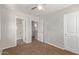 Bedroom with neutral-toned walls, brown carpet, and doors leading to adjoining rooms at 10331 W Devonshire Ave, Phoenix, AZ 85037