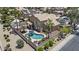 Aerial view of a backyard oasis featuring a large pool, covered patio, and privacy wall at 1244 W Straford Ave, Gilbert, AZ 85233