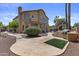 Landscaped backyard featuring a patio, built-in grill, decorative shrubs, and large trees at 1244 W Straford Ave, Gilbert, AZ 85233