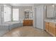 Bathroom features a soaking tub, glass shower, tile floors, and dual vanities at 1244 W Straford Ave, Gilbert, AZ 85233