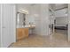 Bright bathroom featuring a vanity with double sinks, and tile floors throughout at 1244 W Straford Ave, Gilbert, AZ 85233