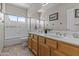 Bright bathroom featuring a vanity with double sinks, a full shower, and tile floors at 1244 W Straford Ave, Gilbert, AZ 85233