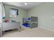 bedroom with bunk beds, light-green walls, large windows and carpeted floors at 1244 W Straford Ave, Gilbert, AZ 85233