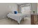 Bedroom with light-colored walls and carpet, large windows, and bright white bedding at 1244 W Straford Ave, Gilbert, AZ 85233