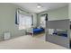 bedroom with bunk beds, light-green walls, large windows and carpeted floors at 1244 W Straford Ave, Gilbert, AZ 85233