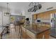 Modern kitchen with stainless steel appliances, granite countertops, and island seating at 1244 W Straford Ave, Gilbert, AZ 85233