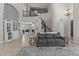 Bright living room with tall ceilings, dark wood staircase, and comfortable seating area at 1244 W Straford Ave, Gilbert, AZ 85233