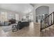 Spacious living area with comfortable furniture, piano, and staircase access at 1244 W Straford Ave, Gilbert, AZ 85233