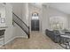 Bright living room with a grand staircase, large windows, high ceilings, and tile floors at 1244 W Straford Ave, Gilbert, AZ 85233