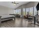 Bright main bedroom features vaulted ceilings, wood floors, a seating area, and multiple windows at 1244 W Straford Ave, Gilbert, AZ 85233