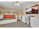 Cozy bedroom featuring daybed, built-in desk, and a ceiling fan at 1264 S Sierra St, Gilbert, AZ 85296