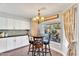 Cozy breakfast nook with chandelier, a wooden table, and views of the landscaped backyard at 1264 S Sierra St, Gilbert, AZ 85296