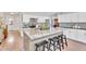 Bright kitchen features a granite island with seating, white cabinets, and stainless steel appliances at 1264 S Sierra St, Gilbert, AZ 85296