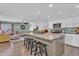 Open concept kitchen with a large granite island, white cabinets and stainless steel microwave at 1264 S Sierra St, Gilbert, AZ 85296