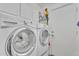 Practical laundry room featuring modern washer and dryer, storage, and a door at 1264 S Sierra St, Gilbert, AZ 85296