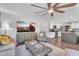 Open-concept living room flows into kitchen with stylish decor and a large flat screen tv at 1264 S Sierra St, Gilbert, AZ 85296