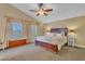 Inviting main bedroom features a large bed, ceiling fan, and multiple windows, offering a relaxing retreat at 1264 S Sierra St, Gilbert, AZ 85296