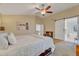 Spacious main bedroom includes a bed, ceiling fan, and view to a bath and upstairs, creating a cozy atmosphere at 1264 S Sierra St, Gilbert, AZ 85296