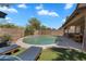 Backyard oasis boasting a sparkling pool, artificial turf, and lounge chairs at 1264 S Sierra St, Gilbert, AZ 85296