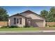 Charming single-story home with a two-car garage and well-manicured landscaping at 1432 W Ridge Rd, Apache Junction, AZ 85120
