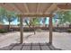 Backyard with patio, desert landscaping and an ornamental tree at 1563 E Peregrine Trl, Casa Grande, AZ 85122