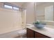 Bathroom featuring a glass vessel sink, and tub with tile surround at 1563 E Peregrine Trl, Casa Grande, AZ 85122
