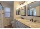 Bathroom featuring dual sinks, granite countertops, and modern fixtures and lighting at 1563 E Peregrine Trl, Casa Grande, AZ 85122