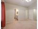 Bedroom view towards a bathroom with neutral carpet and walls, offering a serene space at 1563 E Peregrine Trl, Casa Grande, AZ 85122