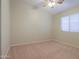 Bedroom featuring soft carpet flooring and a window with bright, natural light at 1563 E Peregrine Trl, Casa Grande, AZ 85122