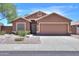 Charming single-story home featuring a low-maintenance desert landscape, tile roof and a two-car garage at 1563 E Peregrine Trl, Casa Grande, AZ 85122