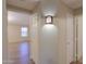 Hallway with a decorative light fixture and view into a bedroom at 1563 E Peregrine Trl, Casa Grande, AZ 85122
