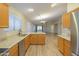 Open concept kitchen with granite countertops, stainless steel appliances, and hardwood floors at 1563 E Peregrine Trl, Casa Grande, AZ 85122