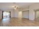 Bright living room with wood floors, neutral colors, and access to a sunroom at 1563 E Peregrine Trl, Casa Grande, AZ 85122