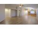 Spacious living room featuring wood-style floors, neutral walls and an open floor plan at 1563 E Peregrine Trl, Casa Grande, AZ 85122