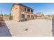 Spacious backyard features minimal landscaping with block wall fencing and mature trees at 15985 W Bartlett Ave, Goodyear, AZ 85338