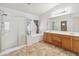 Main bathroom with glass shower and double vanity at 15985 W Bartlett Ave, Goodyear, AZ 85338