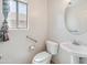 Bright powder room with white fixtures and a window for natural light at 15985 W Bartlett Ave, Goodyear, AZ 85338