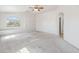Large main bedroom with ceiling fan and arched window at 15985 W Bartlett Ave, Goodyear, AZ 85338