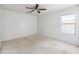 Bedroom featuring a ceiling fan, a window, and carpeted floors at 15985 W Bartlett Ave, Goodyear, AZ 85338