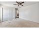 Bedroom with ceiling fan, carpet floors, and closet space at 15985 W Bartlett Ave, Goodyear, AZ 85338